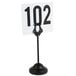 An American Metalcraft black harp table card holder with a number sign on it.