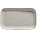 A white rectangular American Metalcraft melamine serving platter with a textured edge.