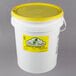 A white bucket with a yellow lid.