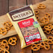 A bag of Snyder's of Hanover Mini Pretzels on a wood surface.