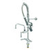 A chrome T&S low profile pre-rinse faucet with a hose attached.