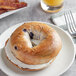 A New York Style blueberry bagel with cream cheese on a plate.