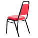 A red Lancaster Table & Seating banquet chair with black metal legs.
