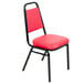 A red Lancaster Table & Seating banquet chair with black legs and a padded seat.