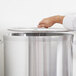 A person using a Vollrath Wear-Ever aluminum lid on a pot.