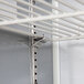 A metal shelf with white metal rods and hooks for a Beverage-Air 2 door refrigerated sandwich prep table.