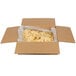 A cardboard box with a bag of Mission yellow corn chips inside.