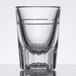 A clear Libbey fluted shot glass with a pour line.
