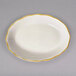 A CAC ivory china platter with a gold rim.