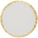 A round white plate with gold foil around it.
