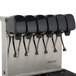 A stainless steel Servend soda fountain machine with six black dispensers.