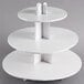 A white three tiered Enjay cupcake stand.