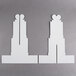 Two white paper cutouts of Enjay cupcake treat stands shaped like towers.