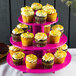 An Enjay pink three-tier cupcake stand with cupcakes on it.