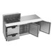 A stainless steel Beverage-Air sandwich prep table with open doors and drawers.