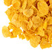 A pile of yellow corn flakes on a white background.