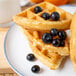 A stack of waffles with IQF blueberries on top.