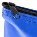 A blue Medique first aid kit bag with a black zipper.