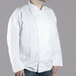 A man wearing a white Chef Revival executive chef coat.