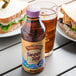 A bottle of Turkey Hill Southern Brewed Sweet Iced Tea on a table next to a sandwich.