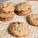 Preformed David's Cookies oatmeal raisin cookies on a woven mat.