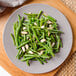 A plate of green beans with Blue Diamond sliced almonds on top.