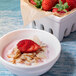 A bowl of yogurt with strawberries and Blue Diamond raw sliced almonds.