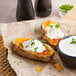 McCain Baked Potato Boat Skins with cream cheese and vegetables on a plate.