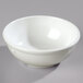A white Carlisle Dallas Ware nappie bowl on a gray surface.