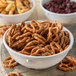 A Carlisle white melamine nappie bowl filled with pretzels and cranberries.