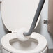 An Unger Ergo toilet bowl swab in a toilet with a mop in it.