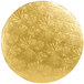 A circular gold plate with leaves on it.