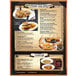 A Menu Solutions Bella Collection menu cover with customizable pages on a wooden table with a menu of a burger, fries, and pizza.