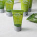 A green bottle of Noble Eco Novo Terra conditioning shampoo with a white flip-top cap.