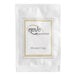 A white packet labeled 'Novo Essentials Shower Cap' containing a hotel and motel shower cap.