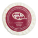 A round white Noble Eco Novo Natura hotel soap disc with a red label.