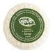 A round white Noble Eco Novo Terra hotel soap disc wrapped in green paper.