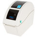 A white Cardinal Detecto thermal label printer with a black label.