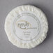 A round white Novo Essentials bath soap with a white label.