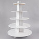 A white round shelf with five tiers for cupcakes.