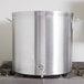 A large silver Vollrath Wear-Ever aluminum stock pot on a stove.