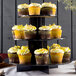 A Enjay 3-tier black cupcake stand holding cupcakes with yellow frosting.