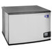 A white and black Manitowoc Indigo NXT air cooled ice machine.
