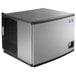 A large rectangular air cooled ice machine with a black and silver finish and a black square on the side.