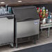 A stainless steel Manitowoc undercounter ice machine on a counter.