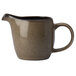 A brown ceramic Oneida Rustic creamer pitcher with a handle.