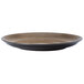 A brown Oneida Rustic chestnut porcelain coupe plate with a black rim.