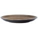 A brown porcelain round coupe plate with a white background and black rim.