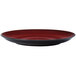 A close up of a crimson red and black Oneida Rustic porcelain coupe plate.
