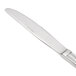 A Oneida Needlepoint stainless steel dinner knife with a silver handle and blade.
